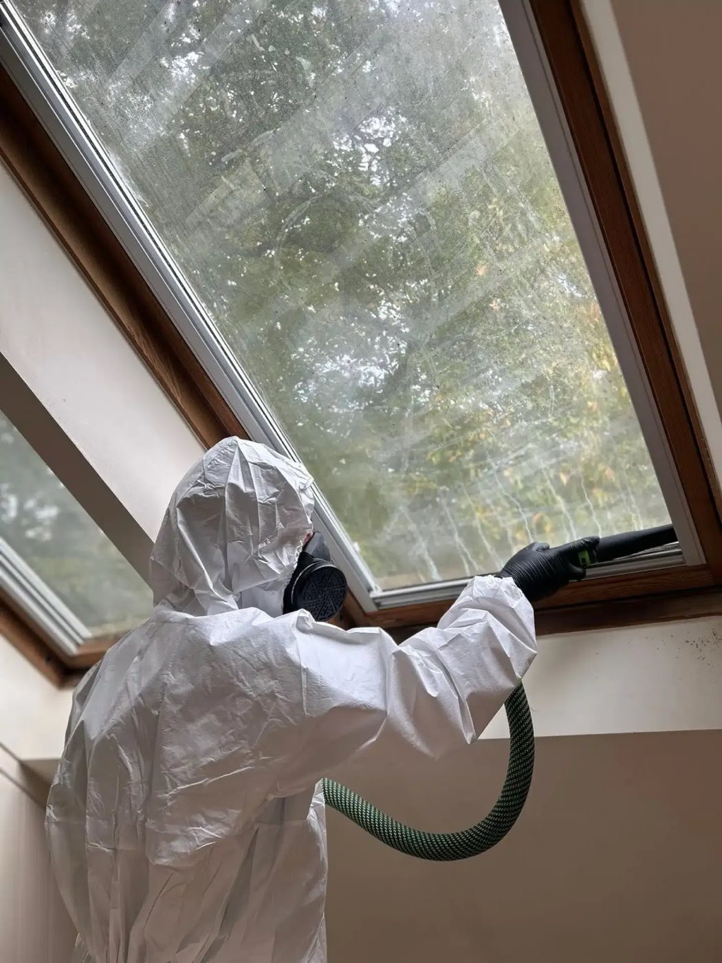 Mould remediation technician working in protective equipment